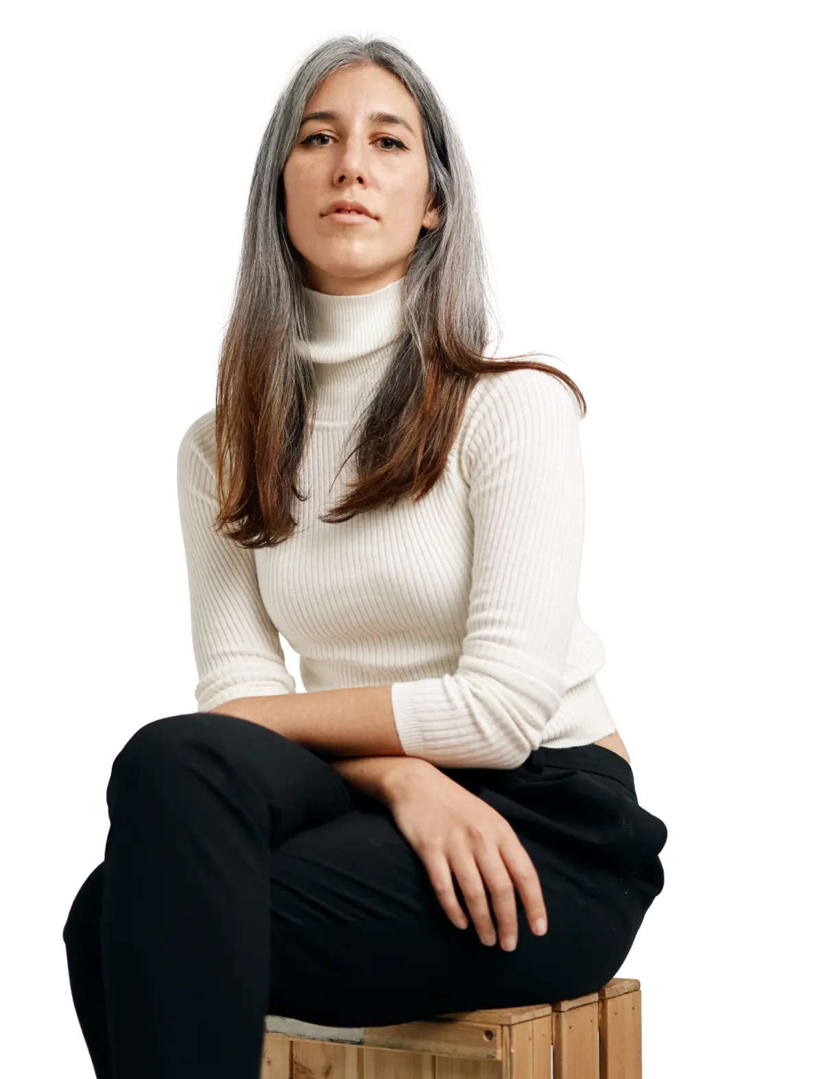 female startup employee in a white jumper sitting with her arms crossed on her lap