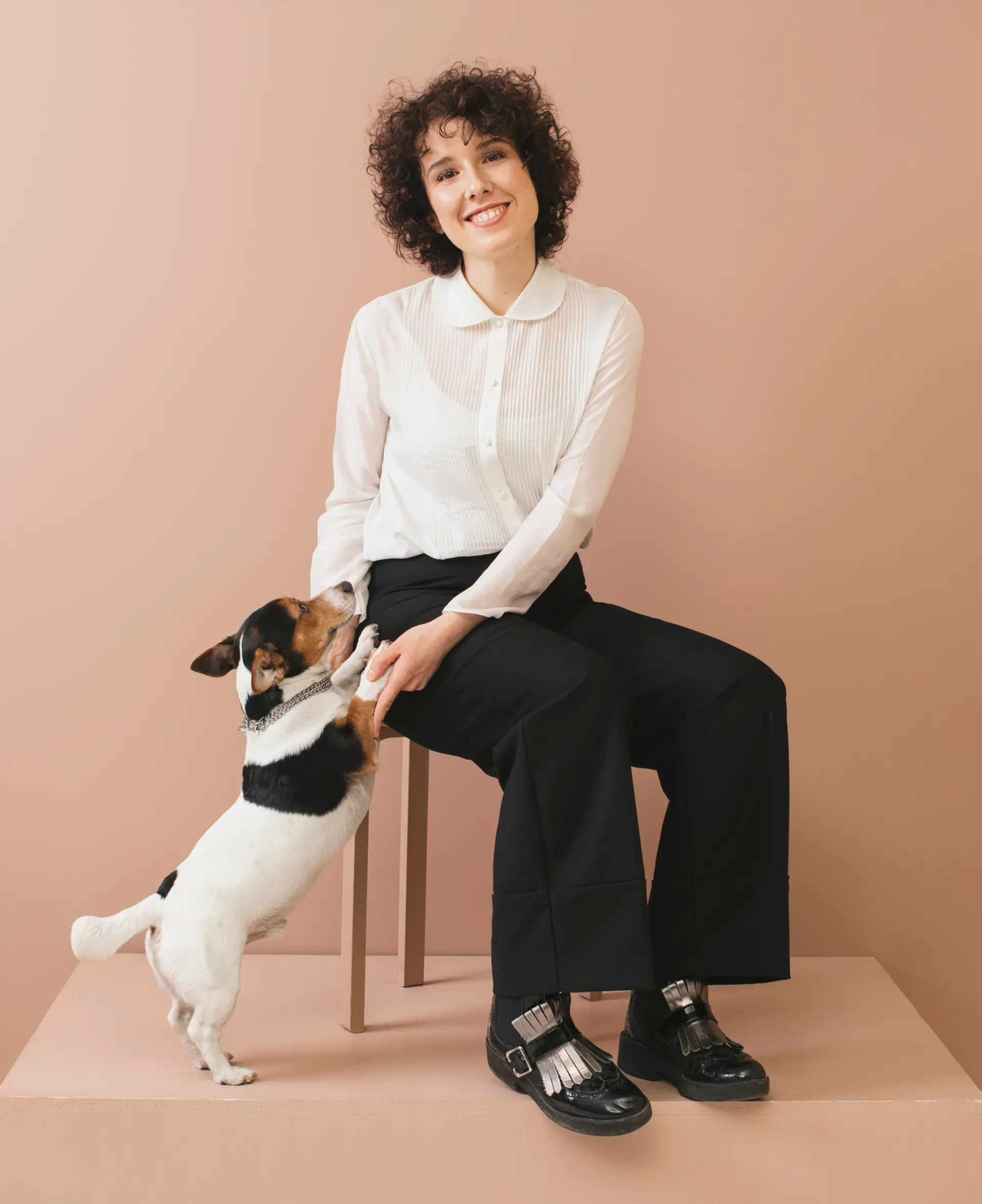 A startup employee with a dog smiling 